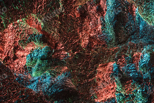 Preview: top view of glossy crumpled foil with colorful lighting reflection in dark