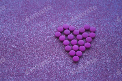 Preview: love shaped from purple pink pills. concept of medical and love