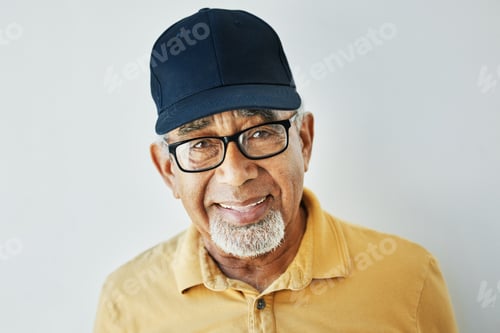 Preview: Elderly man, hat and glasses with modern style, casual and trendy fashion in studio with smile. Hap
