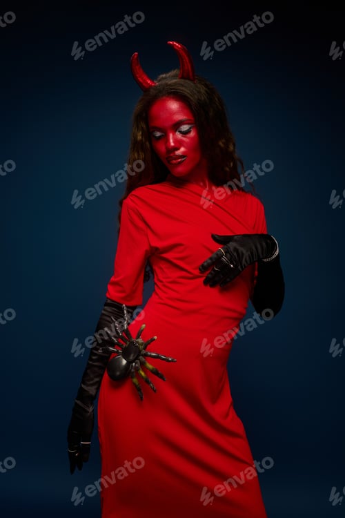 Preview: A striking woman in a red devil costume embracing Halloween festivities with style
