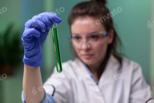 Preview: Woman Scientist Inspecting a Test Tube Experiment