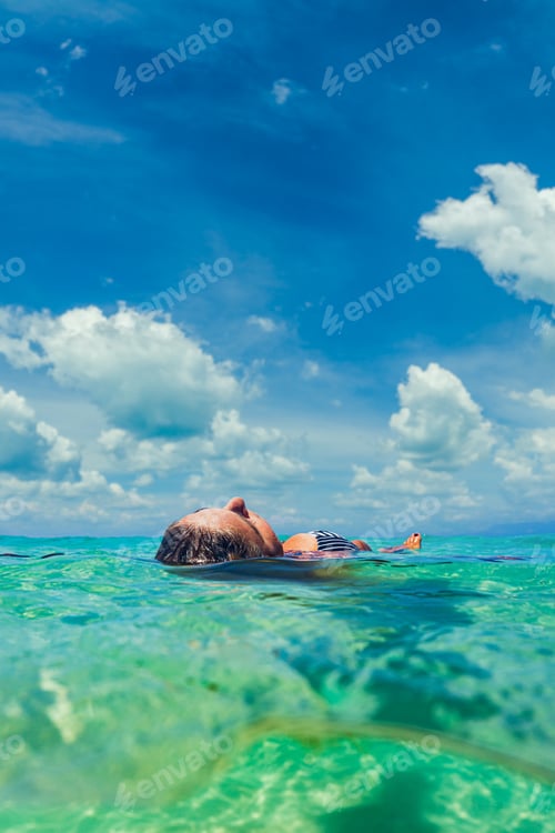 Preview: Woman swimming underwater in the Indian ocean
