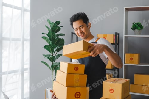 Preview: Young asian sme business man in apron working at warehouse home office freelancer retail logistic