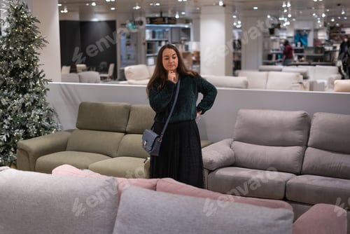 Preview: Woman choosing sofa in mall