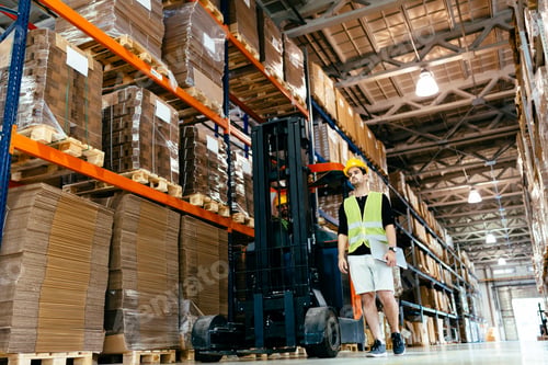 Preview: Warehouse worker doing logistics work with forklift loader