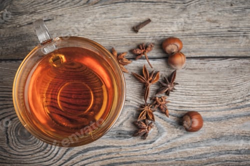 Preview: aromatic hot cinnamon tea on wooden table