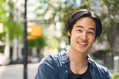 Preview: Smiling asian student standing in university campus, education concept