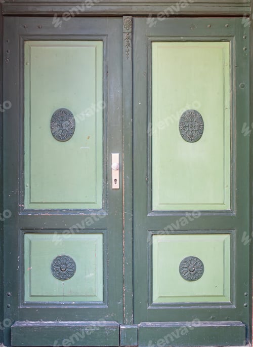 Preview: Green historic double doors with decorative panel medallions. Vintage green doors.