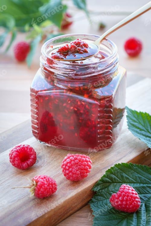 Preview: Raspberry jam and fresh berries on a wooden table