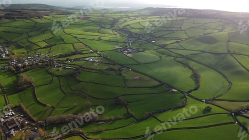 Preview: Aerial view of a rural landscape of green fields and a small town.