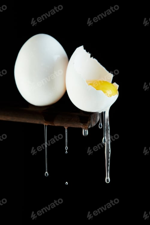 Preview: Chicken eggs, one egg is broken in which the yolk is visible and the white flows down