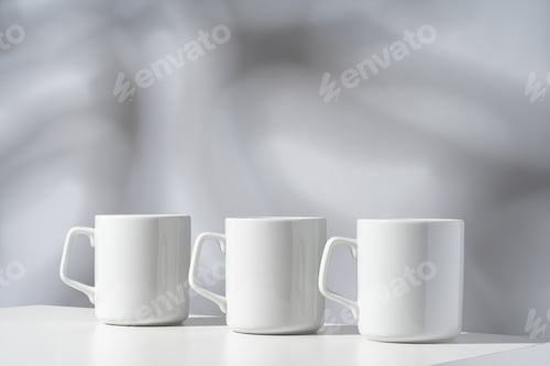 Preview: White ceramic mugs on gray background with shadows