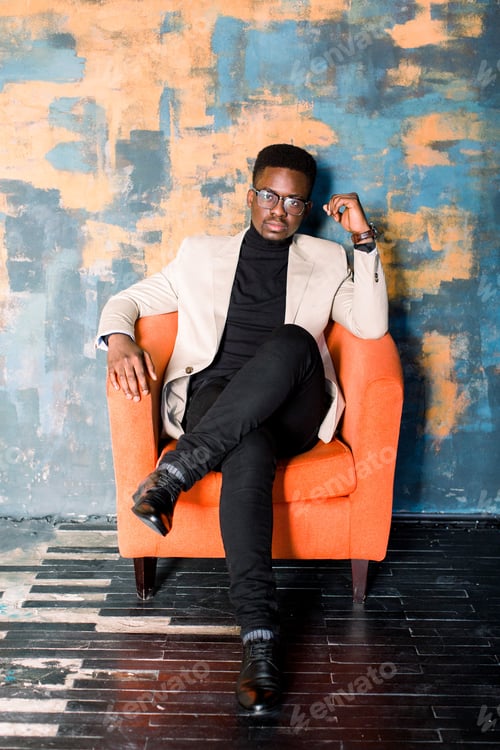 Preview: Portrait of a young handsome african american man in an elegant suit and glasses