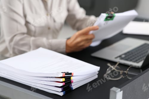 Preview: Businesswoman working at table in office, focus on documents. Space for text