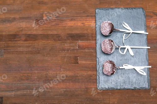 Preview: Delicious sweet chocolate cake pops,popsicles white sprinkles,pastry,desserts on stick. Tasty food