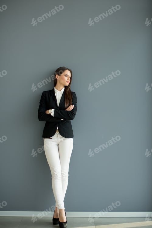 Preview: Young bussiness woman by the wall
