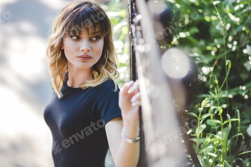 Preview: Shallow focus shot of a blonde woman looking over her shoulder in Bosnia and Herzegovina