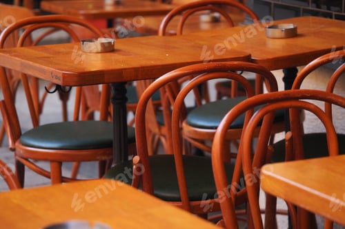 Preview: Tables and chairs in a cafe setting with wooden furniture