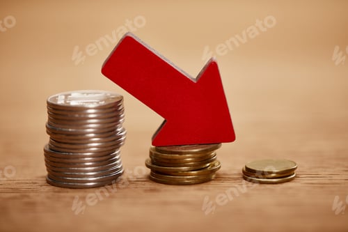 Preview: decreasing chart made of coins with red arrow, bankruptcy concept