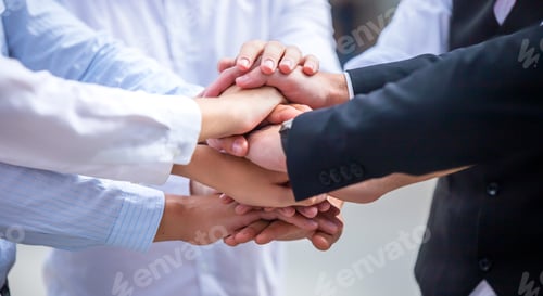 Preview: business team touching hands together after complete a deal in meeting.