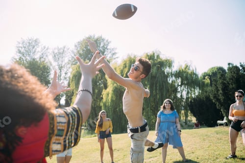 Preview: Group of friends playing football in park