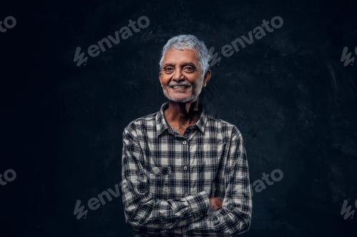 Preview: Joyful elderly man dressed in casual attire against dark background