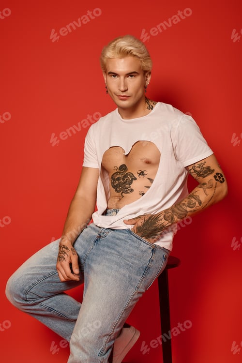 Preview: Stylish young man embodies youth culture with tattoos and casual fashion in a vibrant setting