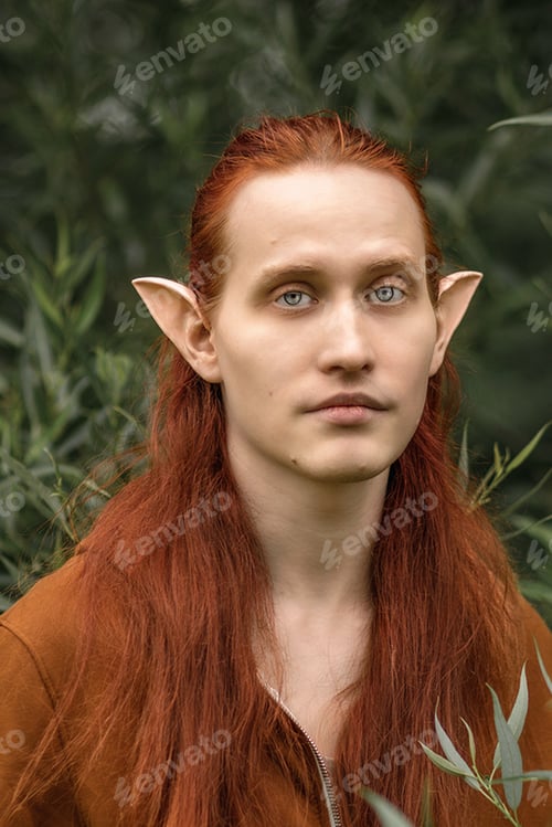 Preview: Artistic elf man with red hair and green eyes in the forest