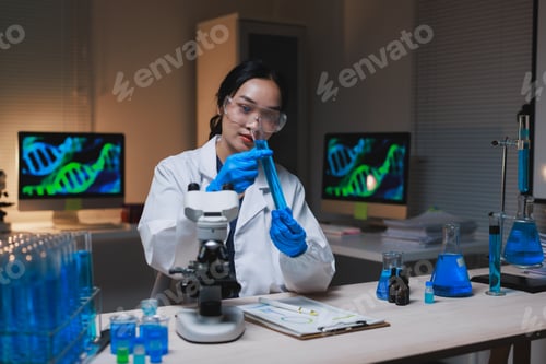 Preview: Female scientist researching dna at a modern laboratory