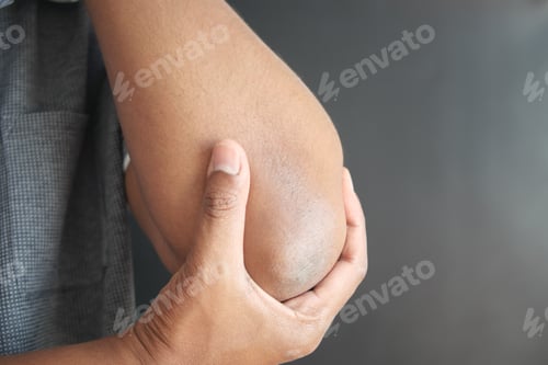 Preview: young man suffering pain on elbow