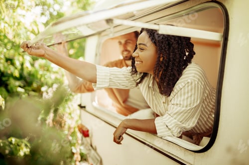Preview: Husband and wife looks out of rv window, trailer