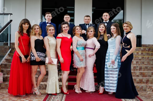 Preview: Group of good-looking graduates posing on the graduation day next to the restaurant.