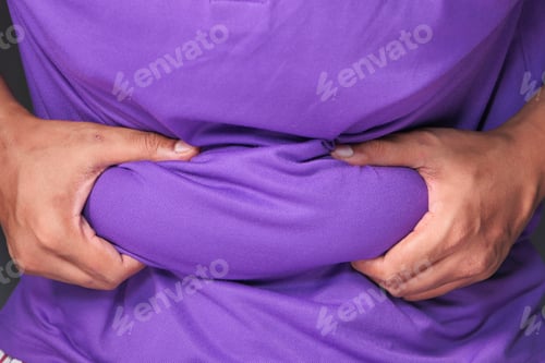 Preview: man's hand holding excessive belly fat, overweight concept
