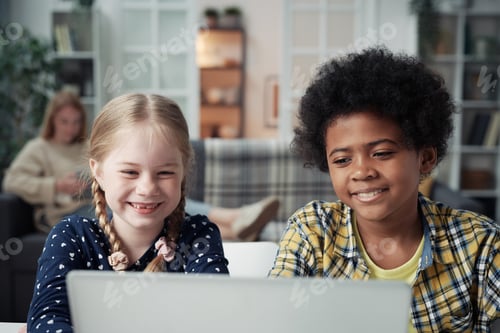 Preview: Children watching video on laptop at home