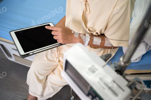 Preview: Middle-aged Asian female patient recovering from illness in hospital room, health care concept.