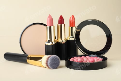 Preview: Different luxury decorative cosmetics and brush on beige background