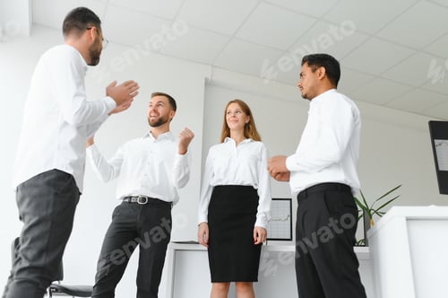 Preview: Group of young business people in smart casual wear working together in creative office