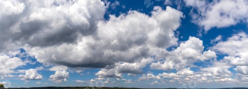 Preview: Panoramic view of blue sky with fluffy clouds over the land