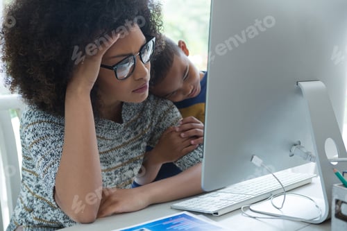 Preview: Mother with his son looking at computer