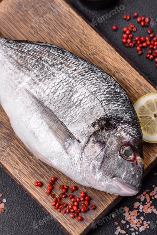 Preview: Whole raw dorado fish with lemon, salt, spices and herbs