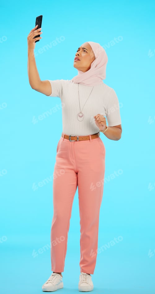 Preview: Woman, phone and lost signal in studio isolated on a blue background for connection problem. Cellph