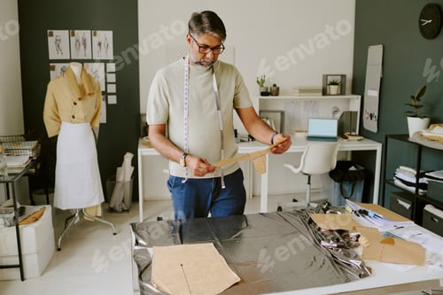 Preview: Mature Tailor Holding Stencil