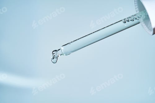 Preview: Pipette with serum on a blue background.