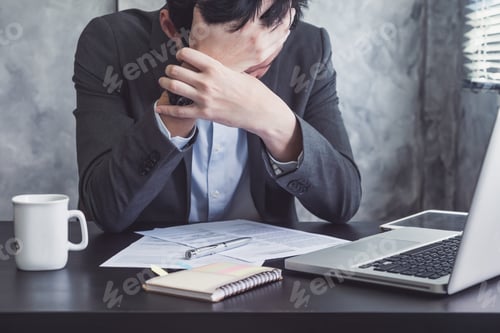 Preview: Close up of Depressed businessman sitting in his office room.
