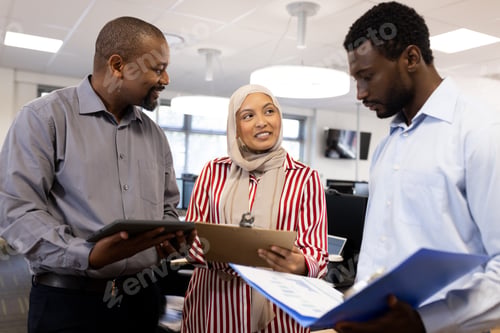 Preview: Happy diverse female and male businesspeople talking and working in office