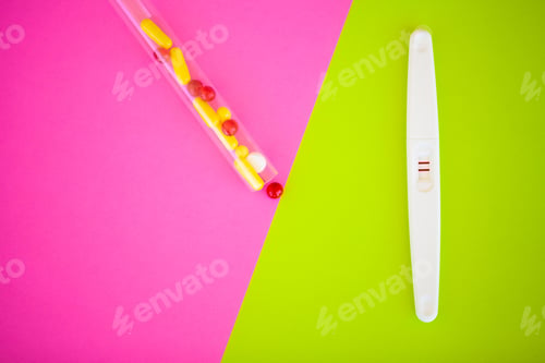 Preview: Close up of pregnancy test and contraceptive pills birth control concept on blue background.