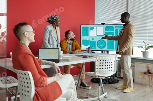 Preview: Group of Business People Discussing Presentation During Office Meeting