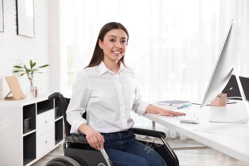 Preview: Portrait of woman in wheelchair at workplace
