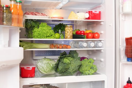Preview: Open refrigerator with fresh food on shelves