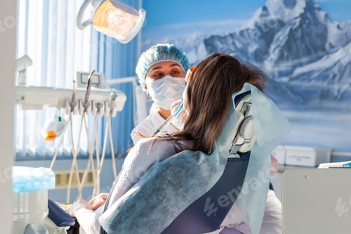 Preview: Woman at the dentist's chair during a dental procedure